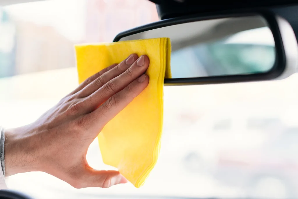 Close up of person cleaning car interior
