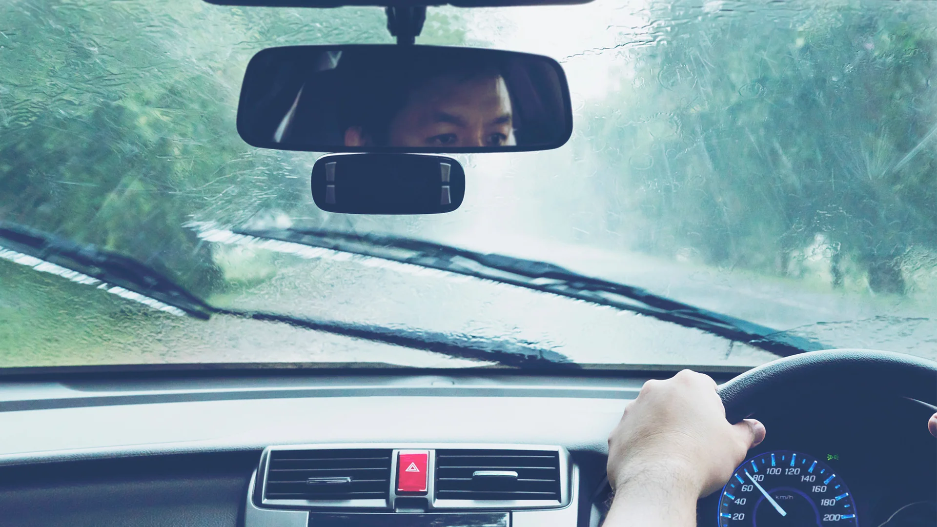 Man driving car in heavy rainfall